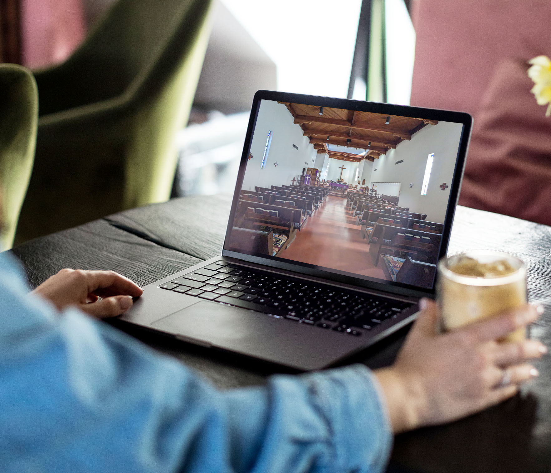 Woman watching live sermon on her laptop