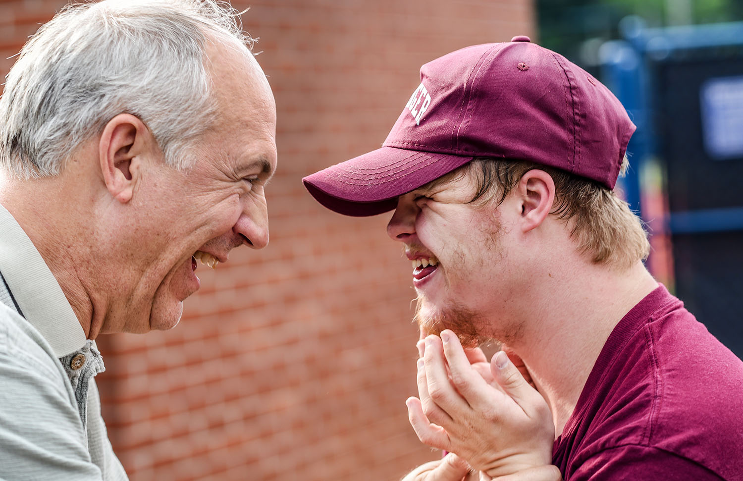 Grandpa and autistic grandson laughing together